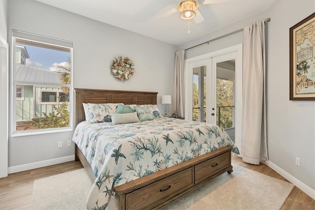 bedroom with access to exterior, french doors, light wood-type flooring, and ceiling fan