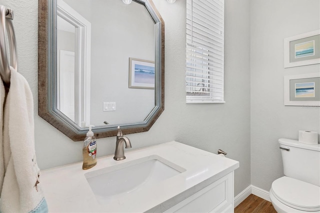 bathroom featuring hardwood / wood-style floors, vanity, and toilet