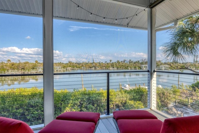 sunroom / solarium with a water view