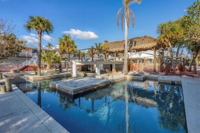 view of swimming pool featuring an in ground hot tub