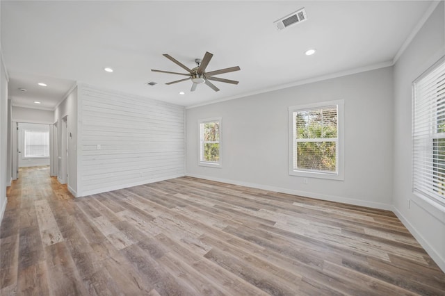 empty room with ceiling fan, plenty of natural light, and ornamental molding