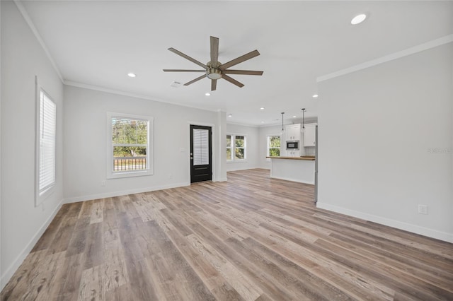 unfurnished living room featuring ceiling fan, light wood-type flooring, and crown molding