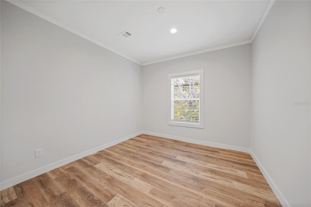 unfurnished room with ornamental molding and light hardwood / wood-style flooring