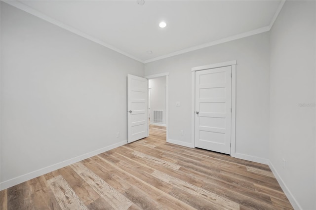 unfurnished bedroom featuring light hardwood / wood-style floors, a closet, and crown molding