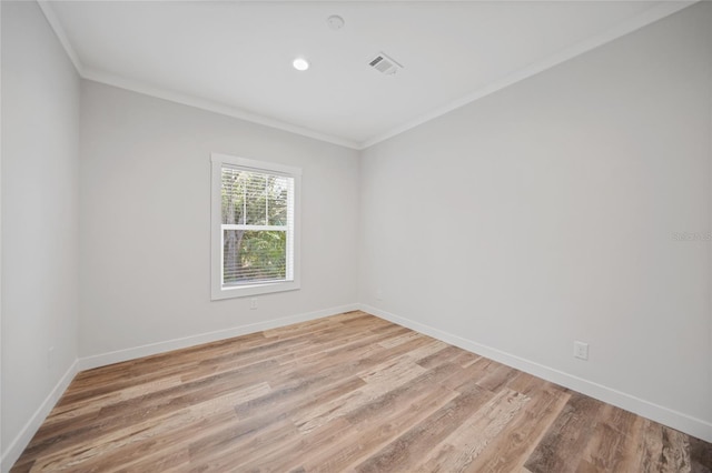 unfurnished room with light hardwood / wood-style floors and ornamental molding