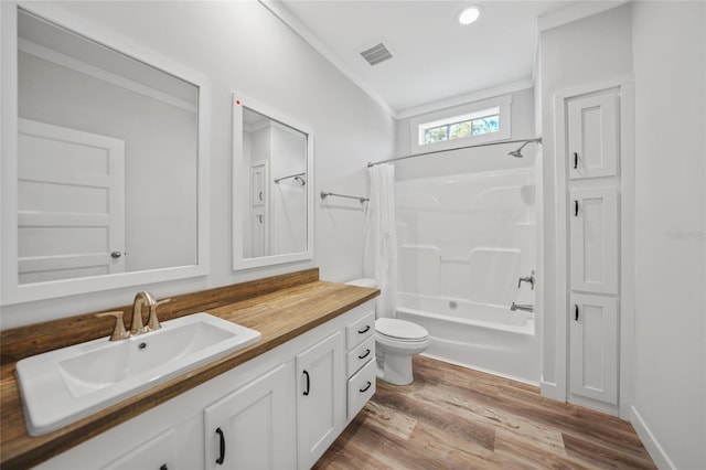 full bathroom featuring vanity, toilet, shower / bathtub combination with curtain, ornamental molding, and wood-type flooring