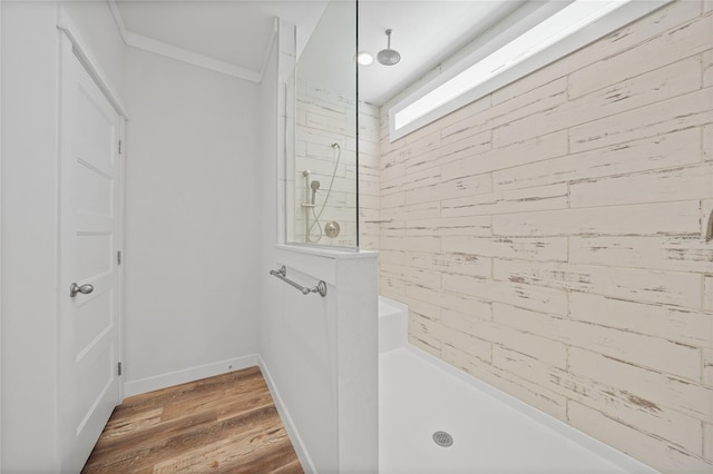 bathroom featuring wood-type flooring, walk in shower, and ornamental molding