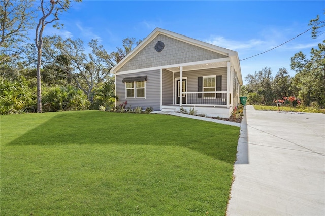 view of front of home with covered porch and a front yard