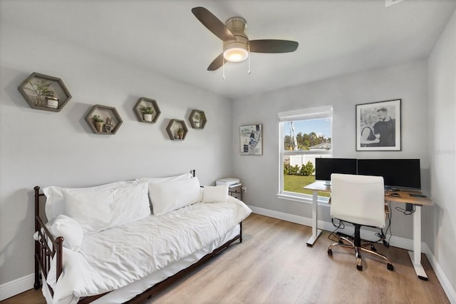 home office with ceiling fan and light wood-type flooring