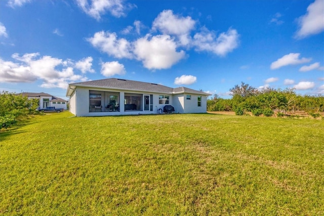 rear view of property with a yard