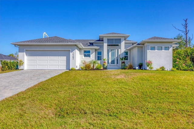 prairie-style house featuring a front lawn and a garage