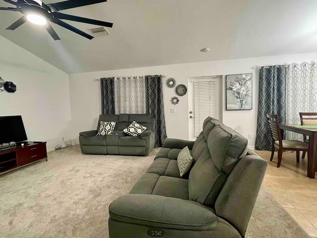 carpeted living room with ceiling fan and lofted ceiling