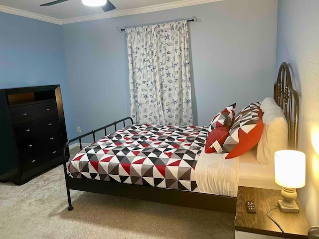 carpeted bedroom with ceiling fan and crown molding