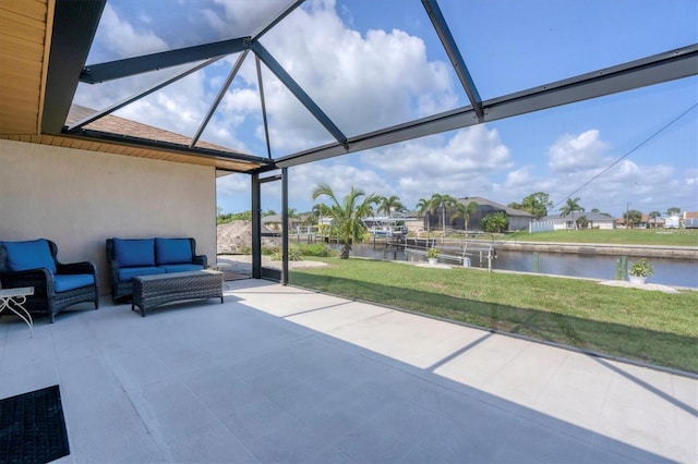 view of patio / terrace with an outdoor living space, glass enclosure, and a water view