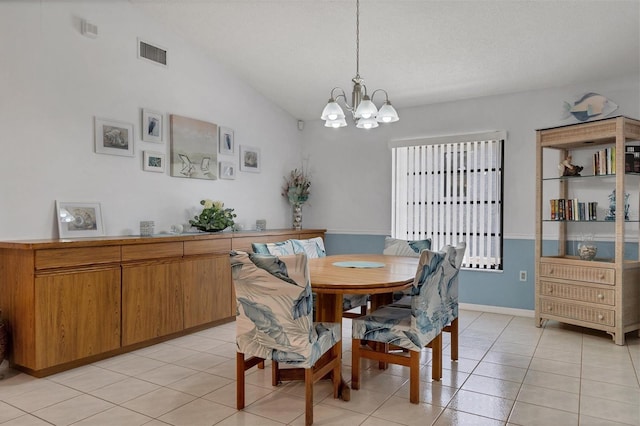 dining area featuring light tile patterned floors, lofted ceiling, a textured ceiling, and a notable chandelier