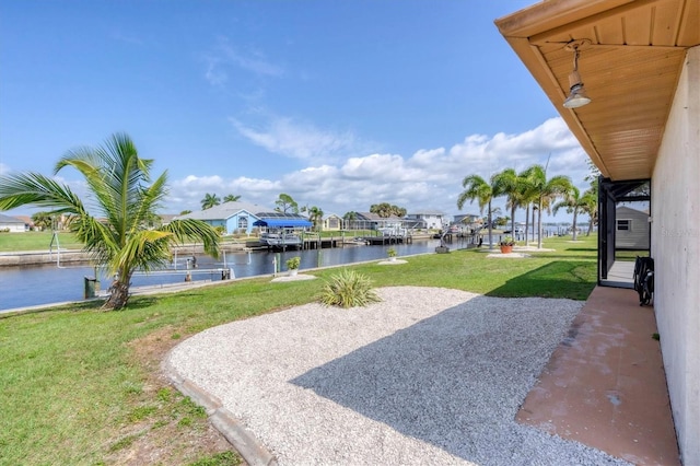 view of yard featuring a water view and a patio