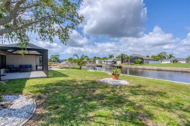 view of yard featuring a water view and a lanai