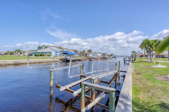 dock area featuring a water view and a lawn