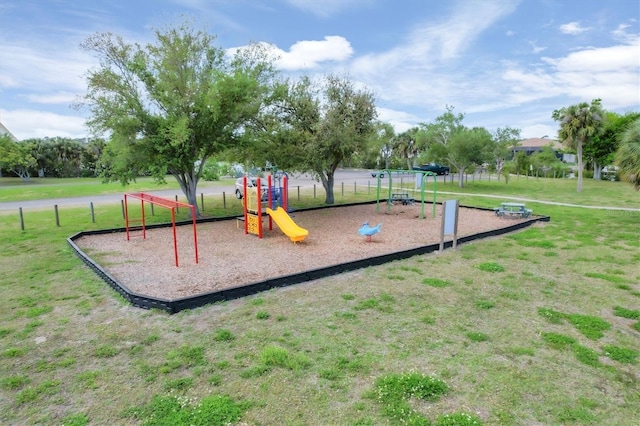 view of playground with a lawn