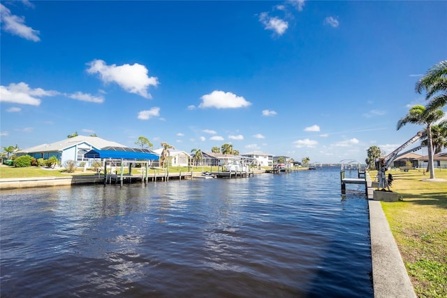 view of dock with a water view and a residential view