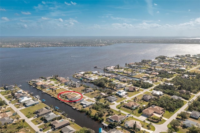 drone / aerial view featuring a residential view and a water view