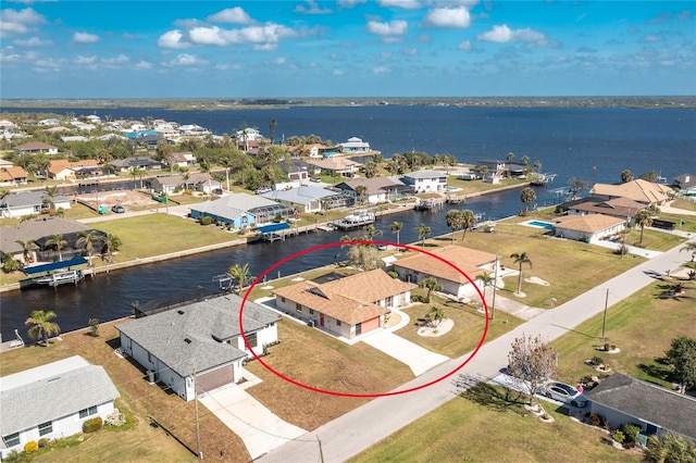 birds eye view of property with a residential view and a water view