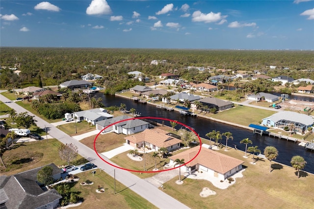 drone / aerial view featuring a water view and a residential view