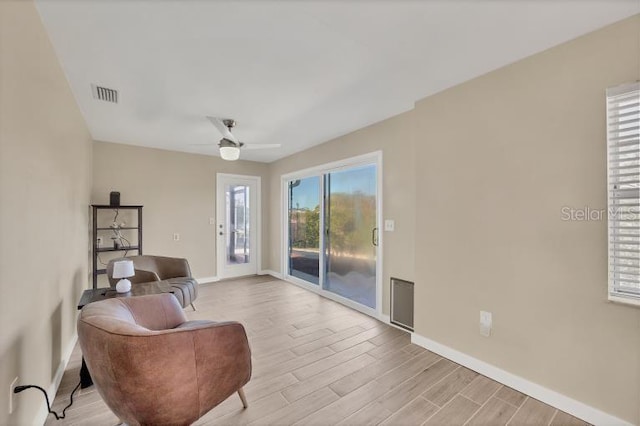 sitting room featuring ceiling fan and light wood-type flooring