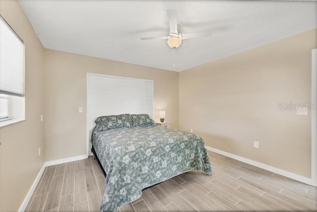 bedroom with ceiling fan and hardwood / wood-style floors