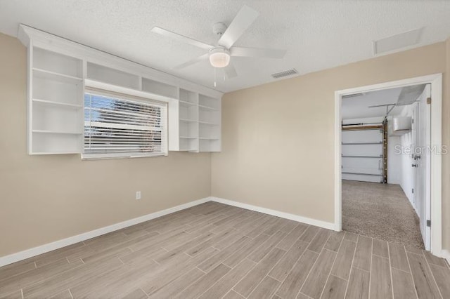 spare room featuring ceiling fan and a textured ceiling