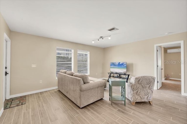 1493 Janet Pl, Englewood, FL 34223 - living room featuring a wall mounted AC and light wood-style flooring