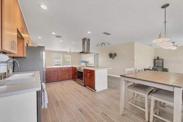 1493 Janet Pl, Englewood, FL 34223 - kitchen with stainless steel electric stove, wall chimney exhaust hood, light countertops, light wood-type flooring, and decorative light fixtures