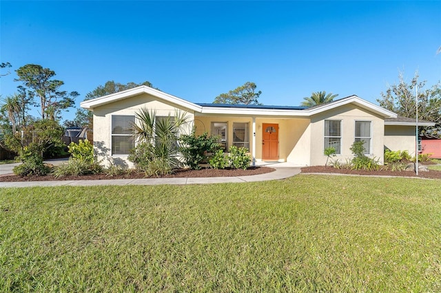 ranch-style home featuring a front lawn