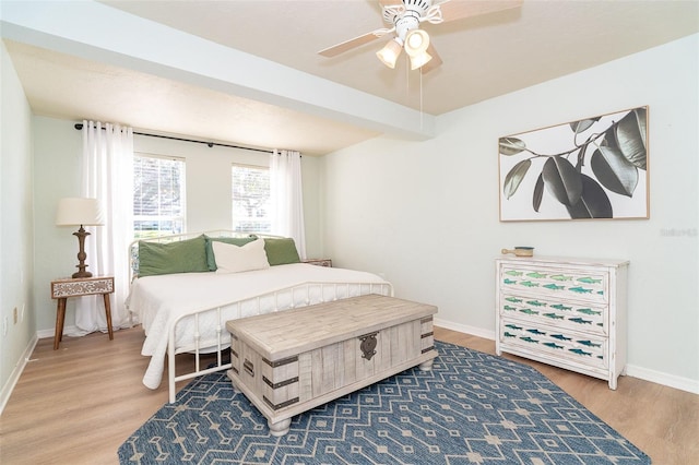 bedroom featuring beamed ceiling, hardwood / wood-style flooring, and ceiling fan