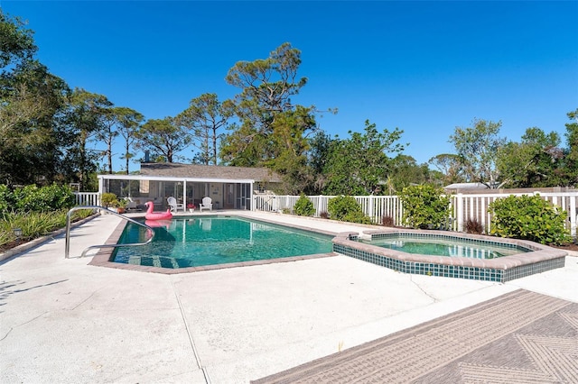 view of pool with an in ground hot tub and a patio