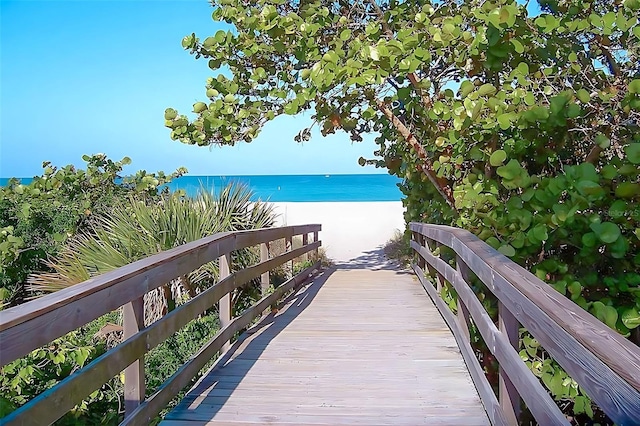 exterior space featuring a beach view and a water view