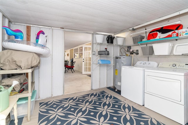 washroom featuring washing machine and dryer, laundry area, and electric water heater