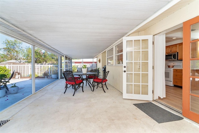 view of patio featuring outdoor dining space and fence