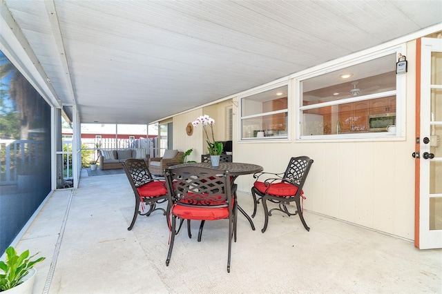 view of patio with outdoor dining space and fence