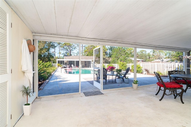 view of patio / terrace featuring an outbuilding, an exterior structure, outdoor dining area, and a fenced backyard