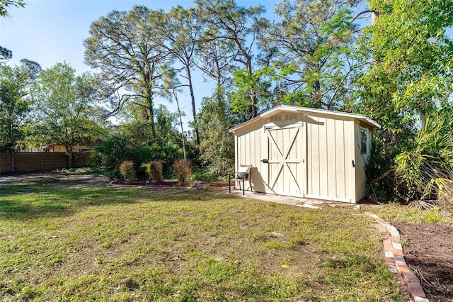 view of shed featuring fence