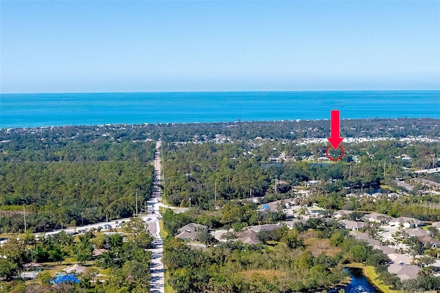 bird's eye view with a water view and a view of trees