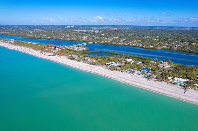 drone / aerial view featuring a water view and a beach view