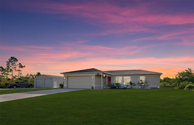 ranch-style house with a lawn and a garage