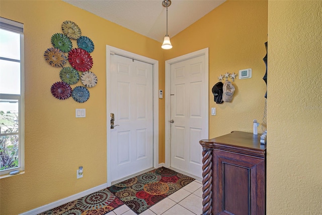 tiled foyer featuring plenty of natural light