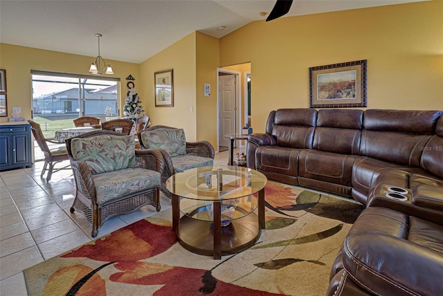 living room with light tile patterned floors, an inviting chandelier, and lofted ceiling