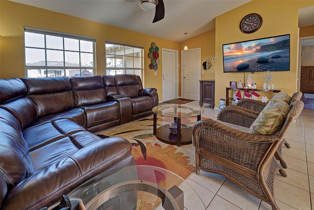 tiled living room featuring ceiling fan and lofted ceiling