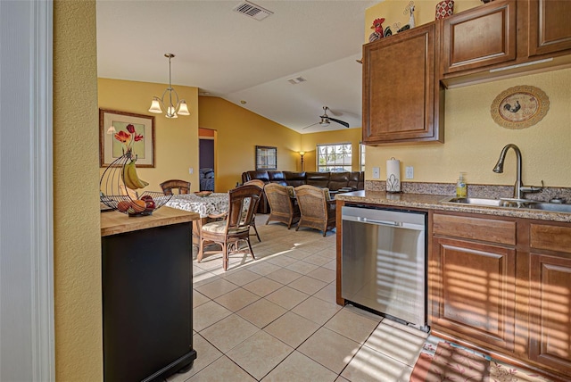 kitchen with stainless steel dishwasher, sink, decorative light fixtures, a notable chandelier, and lofted ceiling