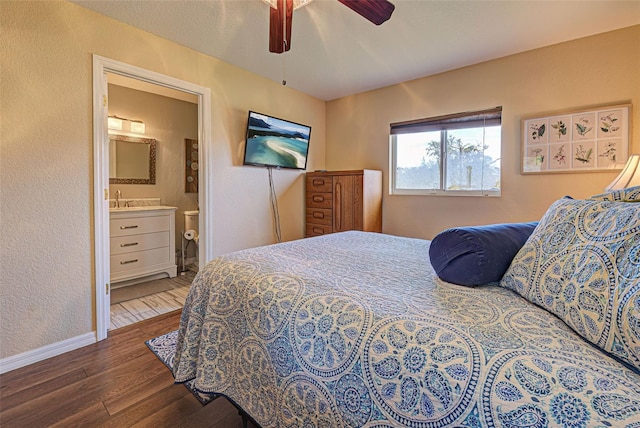 bedroom with dark hardwood / wood-style flooring, connected bathroom, and ceiling fan