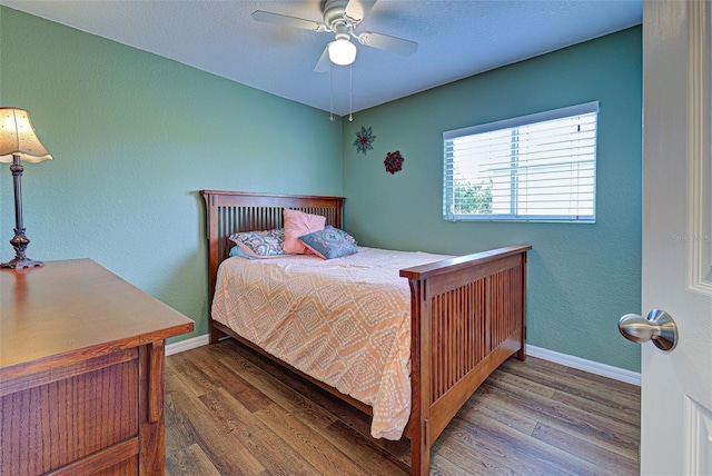 bedroom featuring hardwood / wood-style floors and ceiling fan